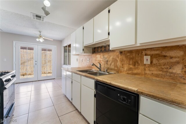 kitchen with black appliances, white cabinetry, french doors, sink, and light tile patterned flooring