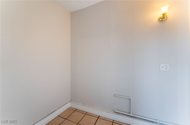 clothes washing area featuring light tile patterned flooring