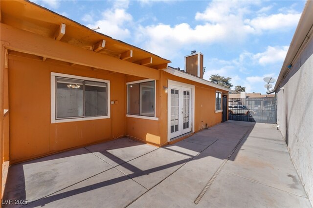 view of side of property featuring french doors and a patio