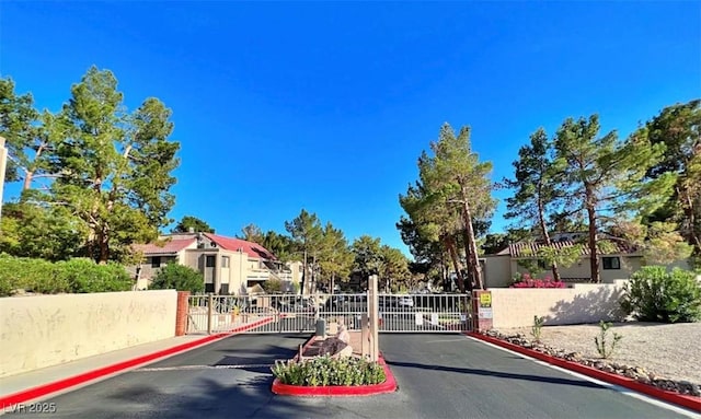 3790 Desert Marina Dr Unit 147, Laughlin, NV 89029 - view of asphalt road with a gate, curbs, and a gated entry
