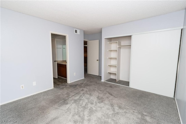 3790 Desert Marina Dr Unit 147, Laughlin, NV 89029 - unfurnished bedroom with carpet floors, a closet, a textured ceiling, ensuite bath, and baseboards