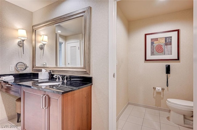 bathroom featuring toilet, tile patterned flooring, and vanity