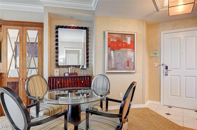 tiled dining space featuring crown molding and french doors