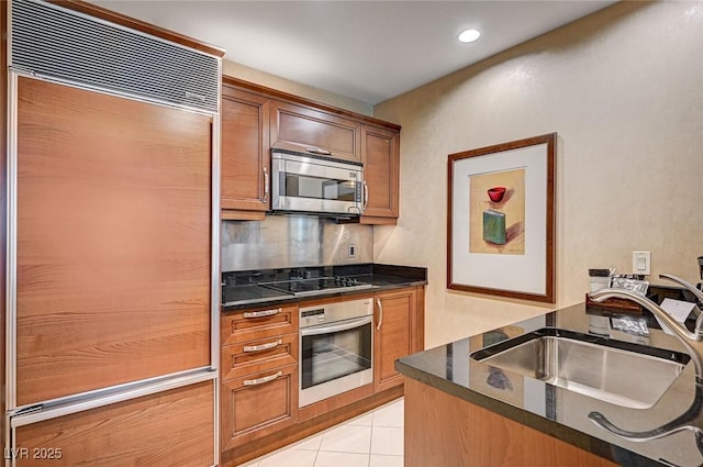 kitchen featuring light tile patterned floors, stainless steel appliances, decorative backsplash, and sink