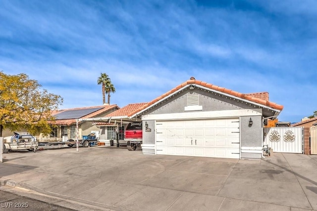 single story home featuring solar panels and a garage