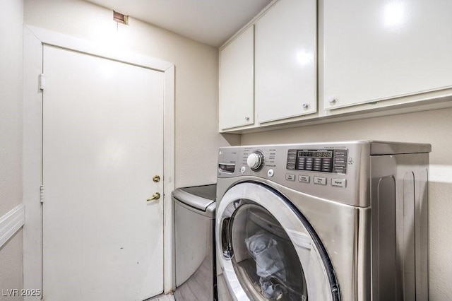 washroom featuring cabinets and washer and dryer