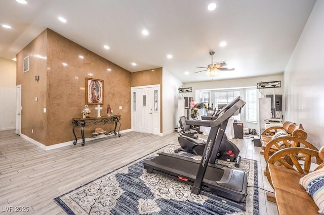 exercise area featuring ceiling fan and light hardwood / wood-style floors