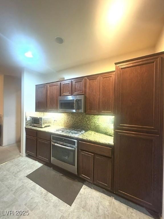 kitchen featuring decorative backsplash and appliances with stainless steel finishes