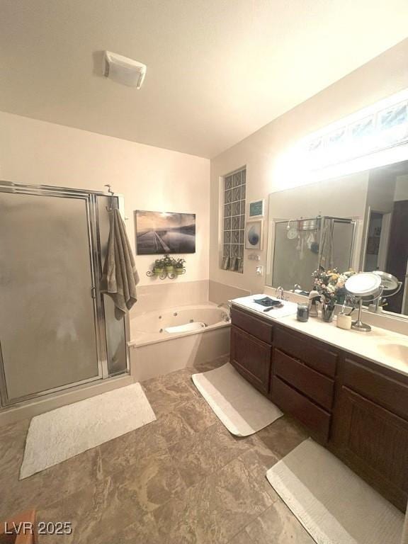 bathroom with vanity and separate shower and tub