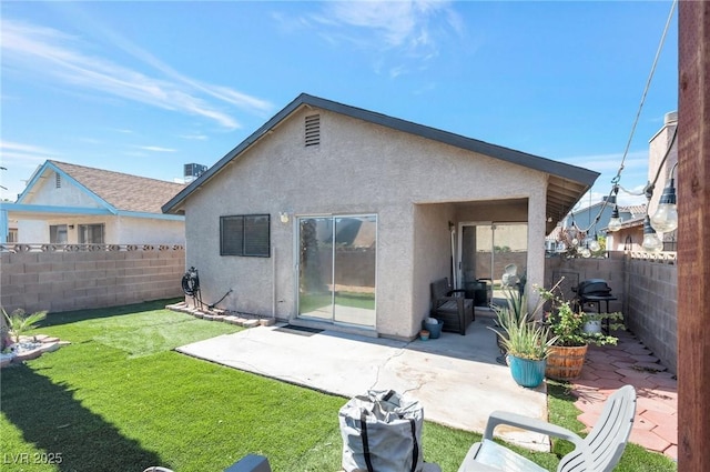 back of property featuring a patio area and a lawn