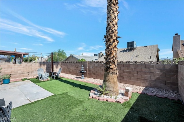 view of yard featuring cooling unit and a patio