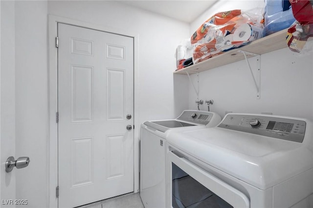 laundry area featuring light tile patterned floors and washer and dryer