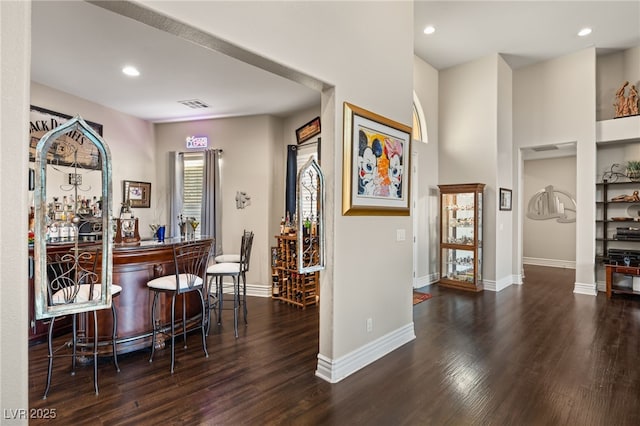 bar with dark wood-type flooring