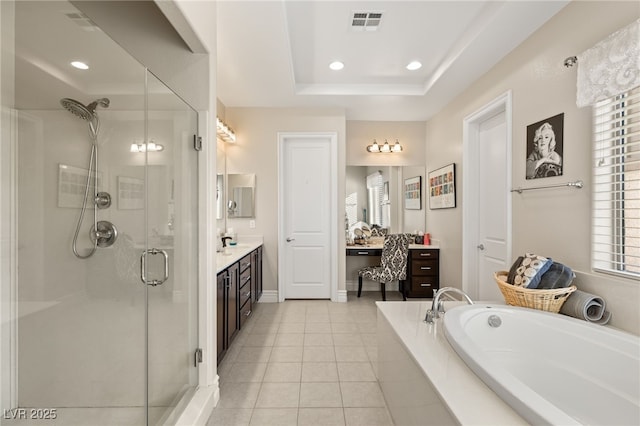 bathroom featuring a raised ceiling, plus walk in shower, tile patterned flooring, and vanity