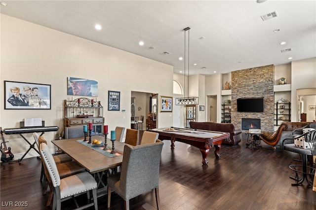 game room with dark hardwood / wood-style floors, billiards, a fireplace, and built in features