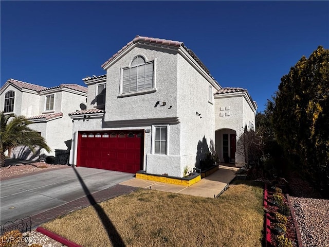 mediterranean / spanish-style house with a front yard and a garage