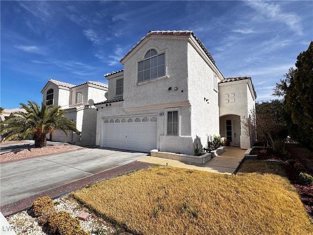 mediterranean / spanish-style home featuring a garage and a front yard