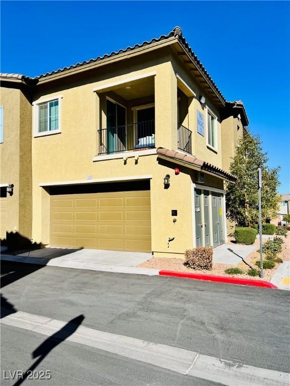 view of front facade with a balcony and a garage