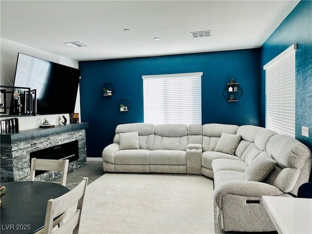 living room with wood-type flooring and a fireplace