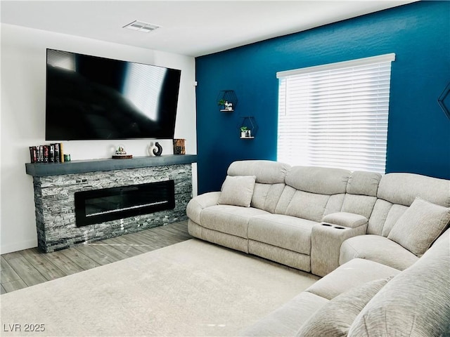 living room featuring a stone fireplace