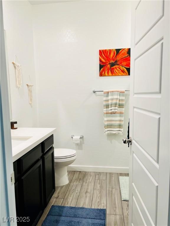 bathroom featuring toilet and vanity