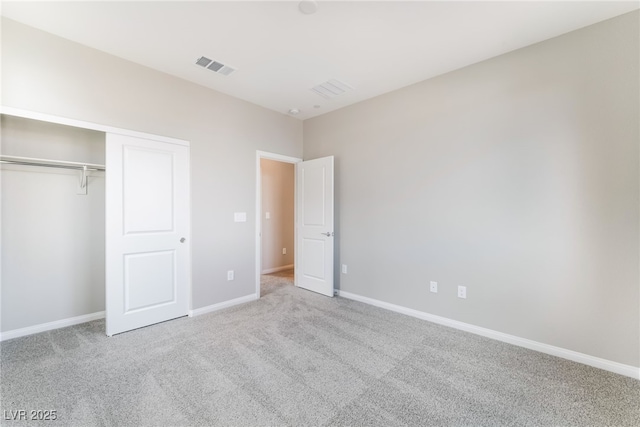 unfurnished bedroom with carpet flooring, baseboards, visible vents, and a closet