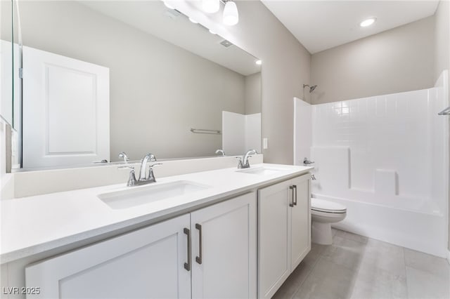 full bathroom with double vanity, toilet, shower / bath combination, and a sink