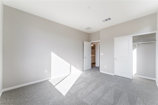 unfurnished bedroom with a closet, visible vents, baseboards, and carpet