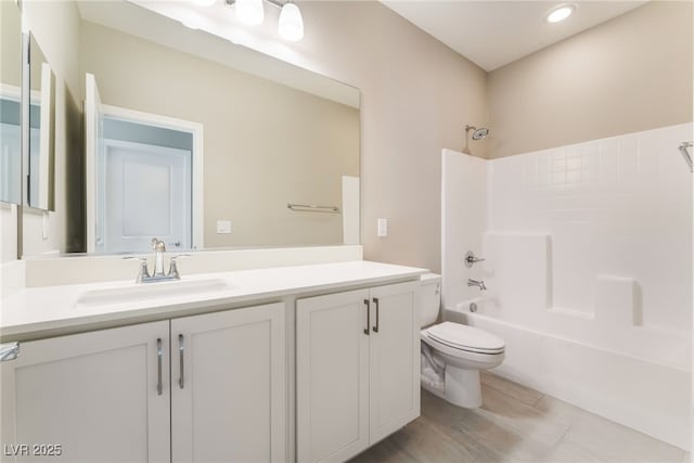 bathroom featuring toilet,  shower combination, and vanity