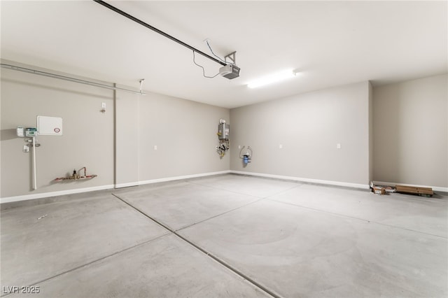 garage with a garage door opener and baseboards