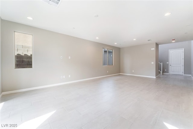 unfurnished room featuring visible vents, recessed lighting, and baseboards