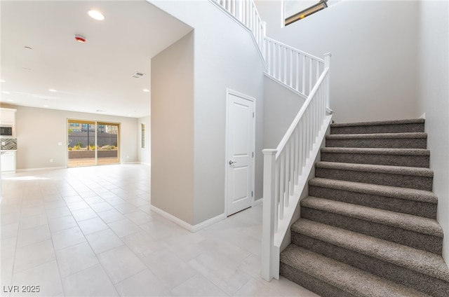 stairs featuring recessed lighting, visible vents, baseboards, and tile patterned floors