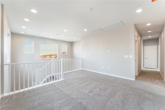 unfurnished room featuring visible vents, recessed lighting, baseboards, and carpet