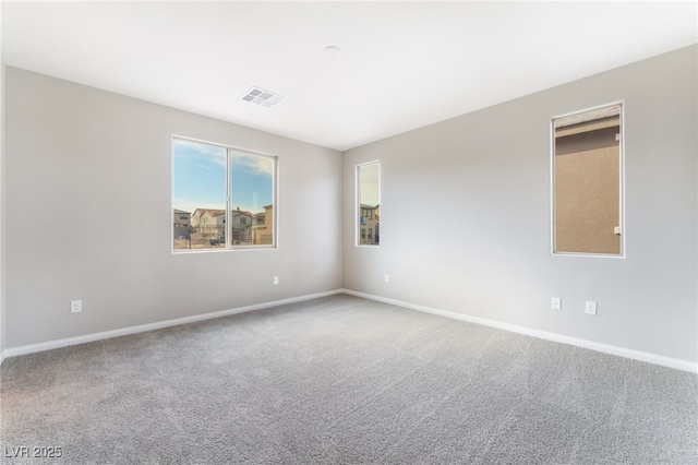 carpeted empty room with baseboards and visible vents