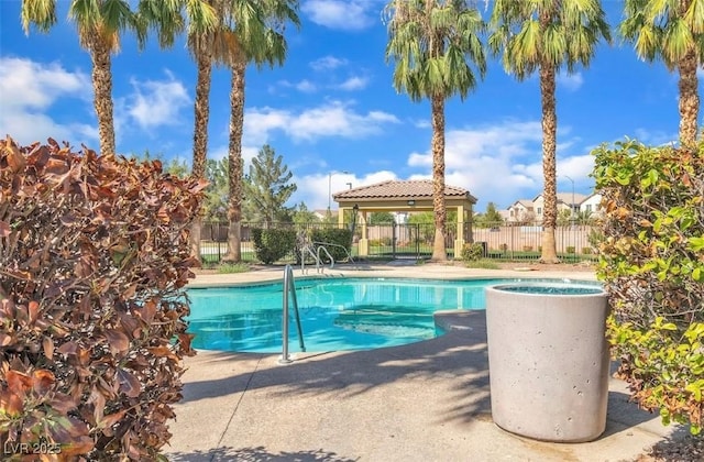 view of swimming pool with a patio, fence, a fenced in pool, and a gazebo