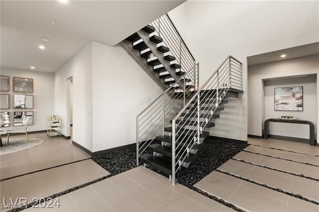 staircase with tile patterned floors