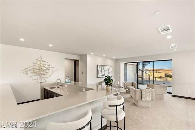 kitchen featuring sink and a breakfast bar