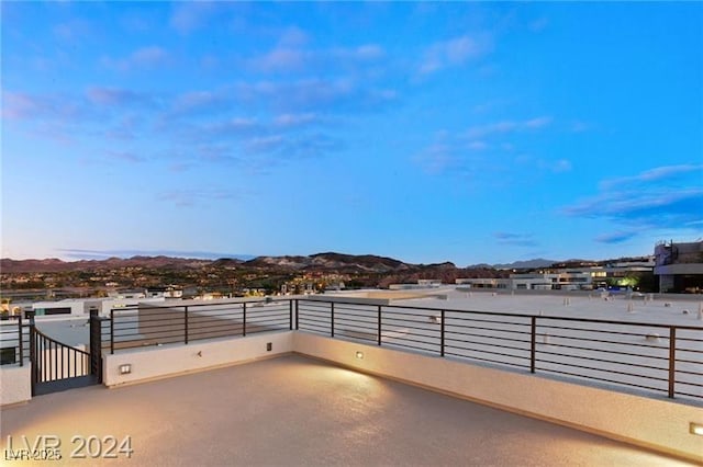 patio terrace at dusk featuring a mountain view