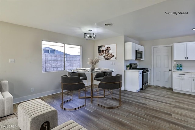 dining room featuring a notable chandelier and hardwood / wood-style flooring