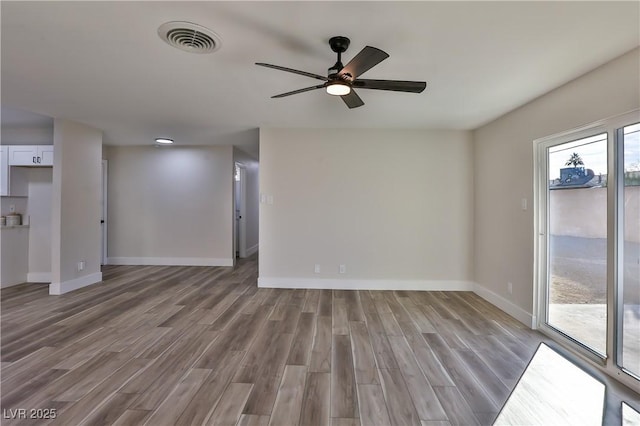 empty room featuring ceiling fan and light hardwood / wood-style flooring