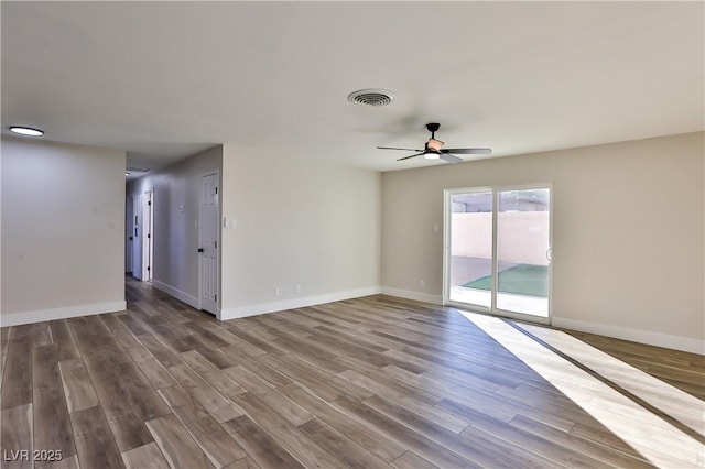 empty room featuring ceiling fan and hardwood / wood-style flooring