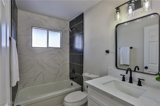 full bathroom featuring toilet, tiled shower / bath, and vanity