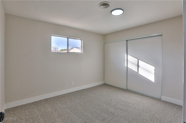 unfurnished bedroom with carpet and a closet