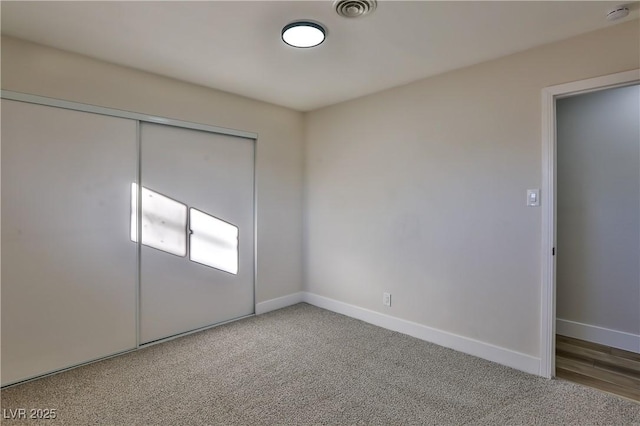 unfurnished bedroom featuring carpet floors and a closet