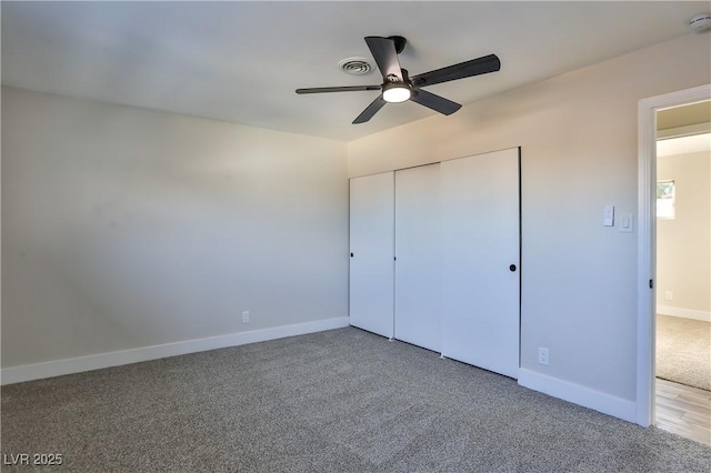 unfurnished bedroom with ceiling fan, a closet, and carpet flooring