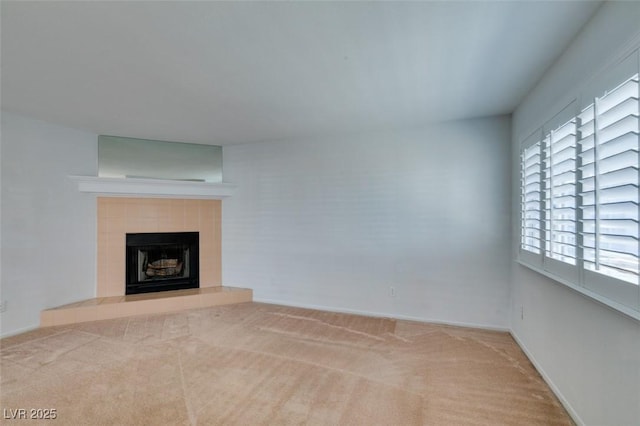 5340 Silvermist Ct Unit 103, Las Vegas, NV 89122 - unfurnished living room with a tiled fireplace, carpet, and baseboards