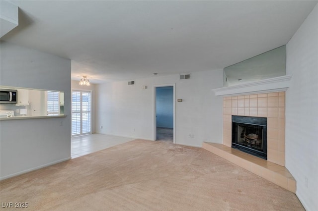 5340 Silvermist Ct Unit 103, Las Vegas, NV 89122 - unfurnished living room featuring carpet floors, a fireplace, baseboards, and a chandelier