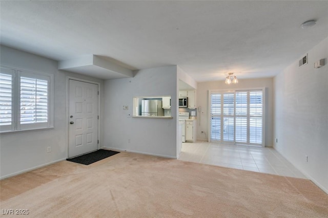 5340 Silvermist Ct Unit 103, Las Vegas, NV 89122 - entrance foyer with light colored carpet, baseboards, and light tile patterned floors