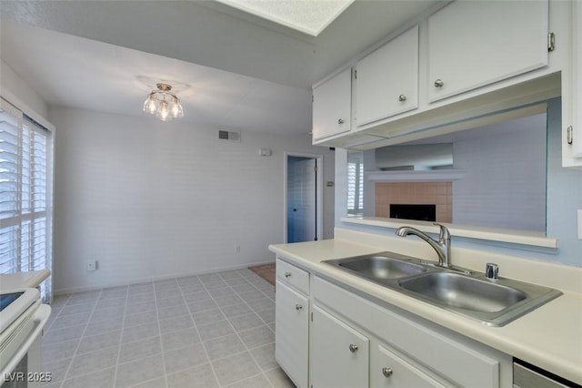 5340 Silvermist Ct Unit 103, Las Vegas, NV 89122 - kitchen with a sink, light countertops, plenty of natural light, and white cabinets