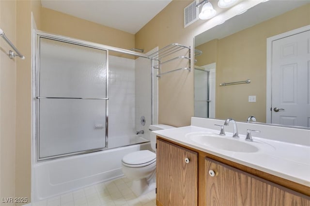 5340 Silvermist Ct Unit 103, Las Vegas, NV 89122 - bathroom with vanity, combined bath / shower with glass door, toilet, and tile patterned flooring